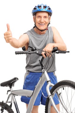 Senior posing behind bicycle and giving a thumb up