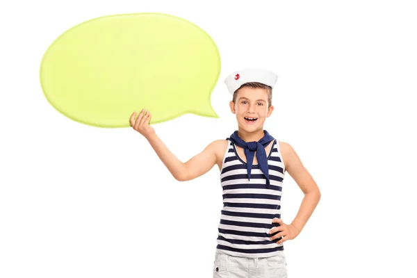 Little kid in a sailor outfit holding a speech bubble — Stockfoto