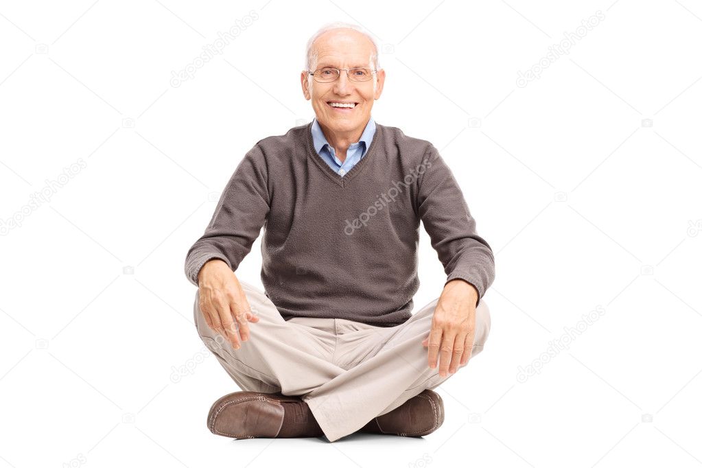 Cheerful senior sitting on the floor 