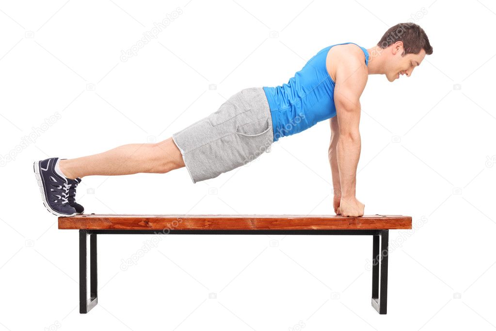 Young athlete doing push-ups on a bench 