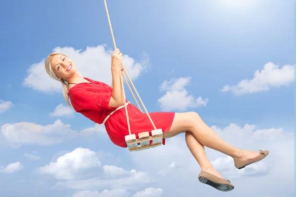 Beautiful woman swinging on a swing — Stock Photo, Image