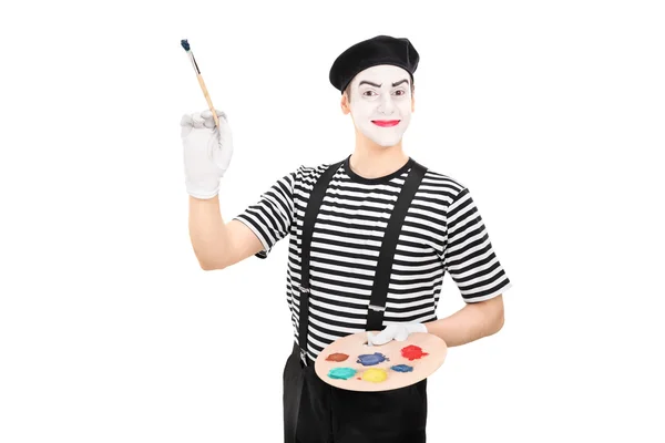 Male mime artist holding a paintbrush — Stock Photo, Image