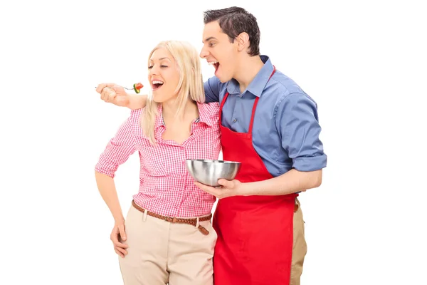 Young man feeding his girlfriend — Stock Photo, Image