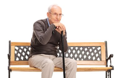 pensive senior gentleman sitting on a bench