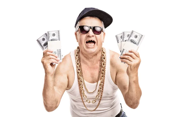 Homem sênior segurando pilhas de dinheiro — Fotografia de Stock
