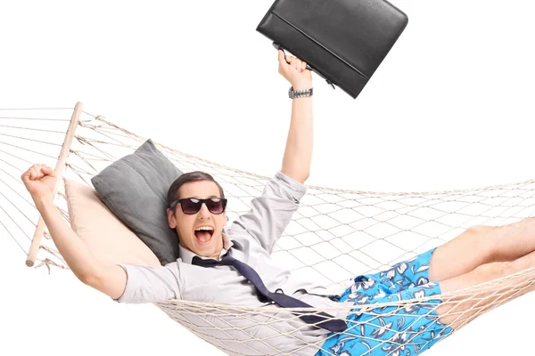 Businessman lying in a hammock and gesturing joy — Stock Photo, Image