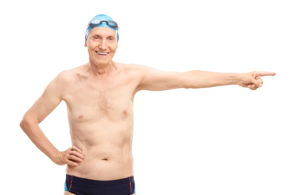 Senior man in swim trunks pointing — Stok fotoğraf