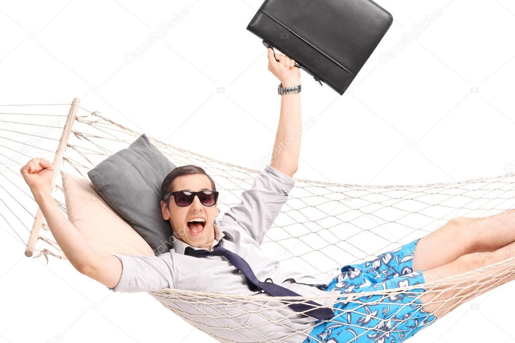 businessman lying in a hammock and gesturing joy
