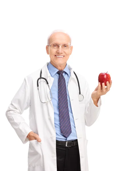 Mature doctor holding a red apple — Stock Photo, Image