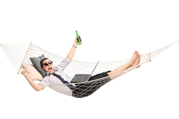 Businessman in hammock working on a laptop — Stock Photo, Image