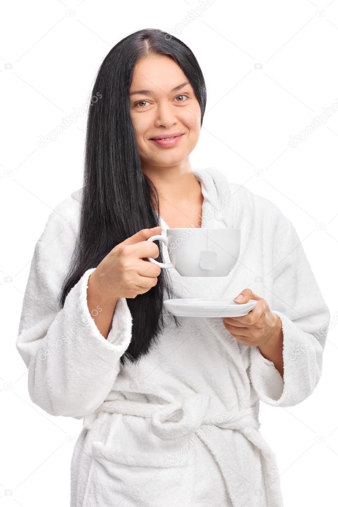 Cheerful woman holding a cup of tea