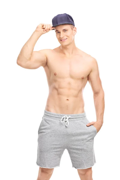 Young man posing with a blue cap — Stock Photo, Image