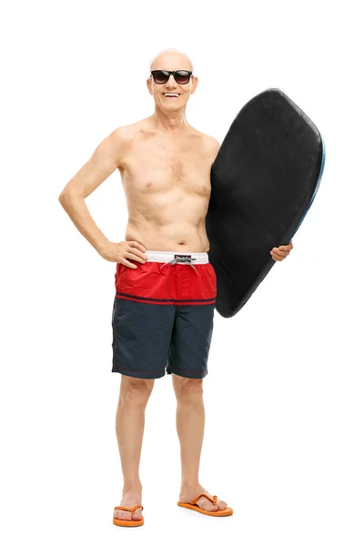 Senior man holding a surfboard — Stock Photo, Image