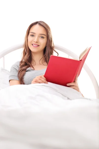 Brunette woman holding a book — Stock Photo, Image