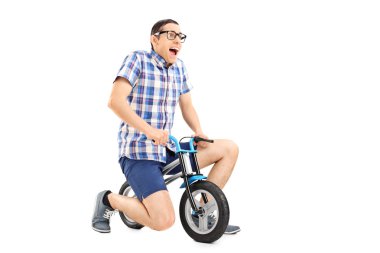 young guy riding a tiny bicycle clipart
