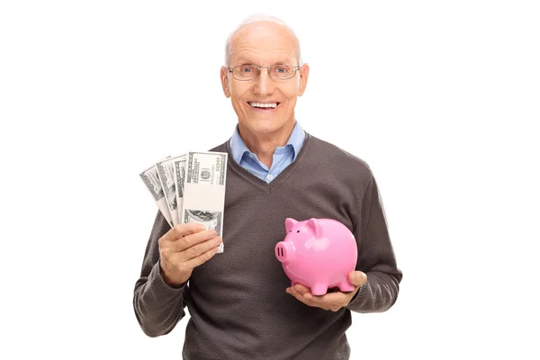 Hombre mayor sosteniendo montones de dinero — Foto de Stock