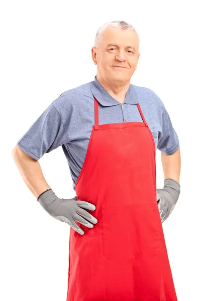 Mature man in a red apron — Stock Photo, Image