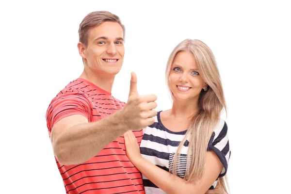 Man posing with girlfriend and giving a thumb up Stock Picture