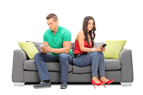 Couple surfing the internet on their phones — Stock Photo, Image