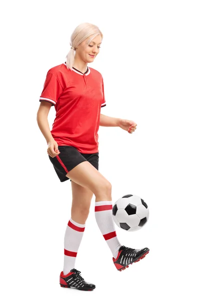 Vrouwelijke voetballer jongleren een bal — Stockfoto