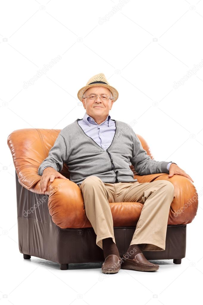 Relaxed senior gentleman sitting in an armchair 
