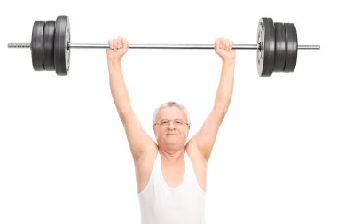 Senior man lifting a heavy barbell