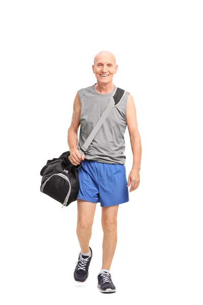 Senior man carrying a sports bag — Stock Photo, Image