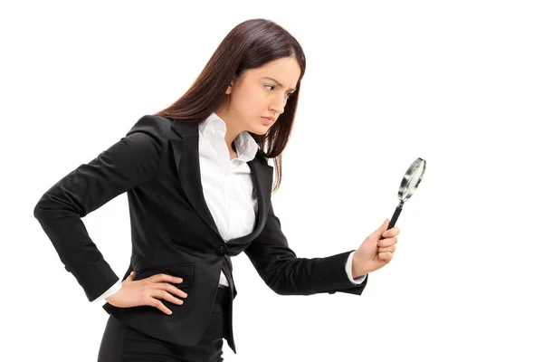 Businesswoman looking through a magnifying glass — Stock Photo, Image