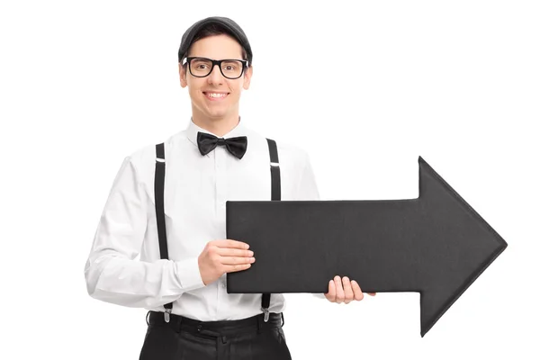 Young man holding black arrow — Stock Photo, Image