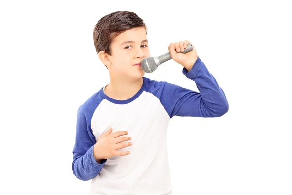 Joyful little kid singing on a microphone — Stock Photo, Image
