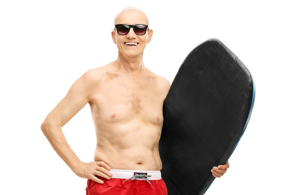 Senior man holding a surfboard — Stock Photo, Image
