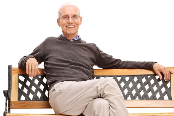 Senior man sitting on a wooden bench — Stock Photo, Image