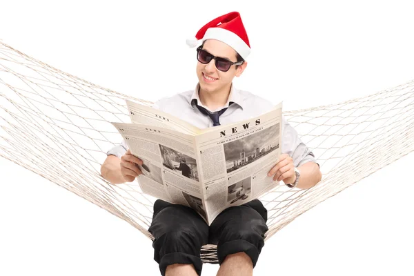 Guy with Santa hat reading a news — Stock Photo, Image