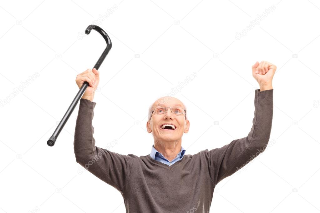 Overjoyed senior man holding cane