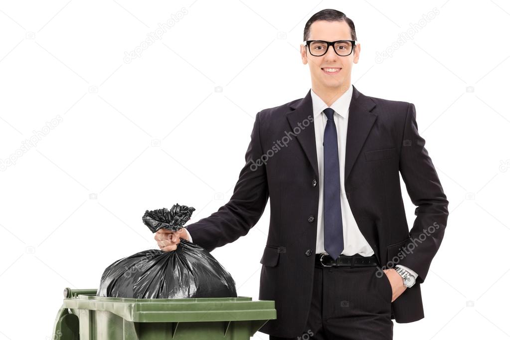 young businessman taking out the trash