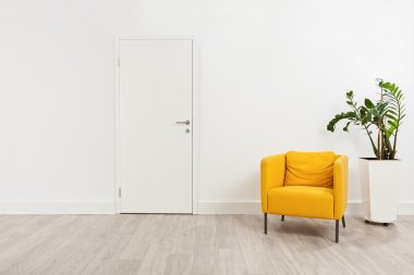 waiting room with a yellow armchair