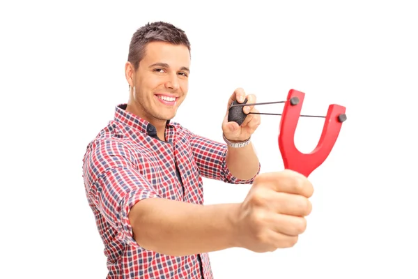 Guy shooting a rock from a slingshot — Stock Photo, Image
