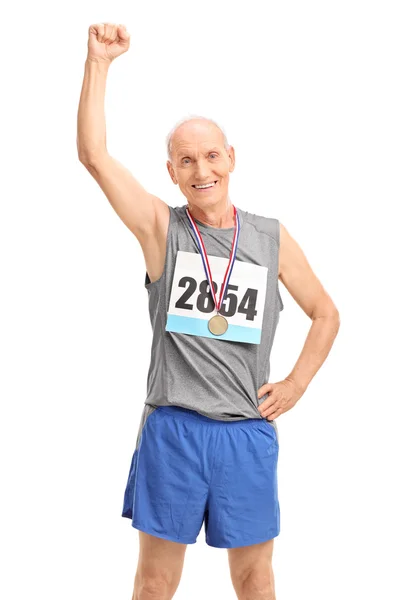 Mature runner raising his fist — Stock Photo, Image