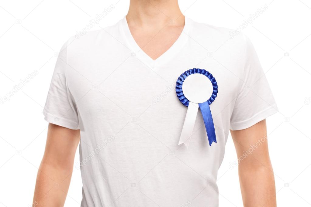 Man wearing a blue award badge