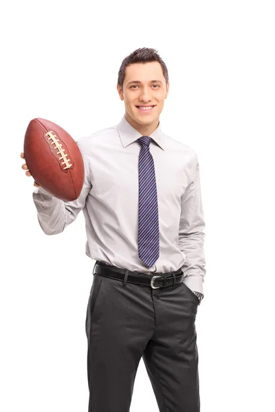 Young businessman holding an American football — Stock Photo, Image