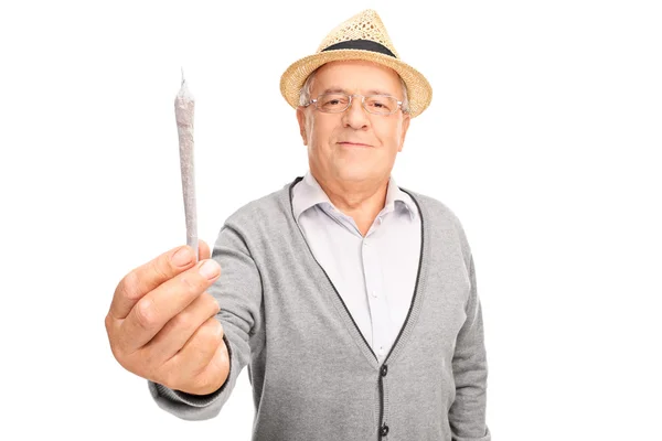 Mature man holding medicinal marijuana — Stock Photo, Image