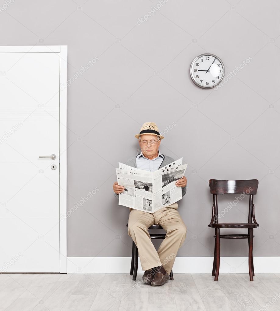 Senior gentleman reading newspaper