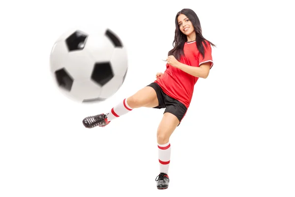 Female football player shooting a ball — Stok fotoğraf