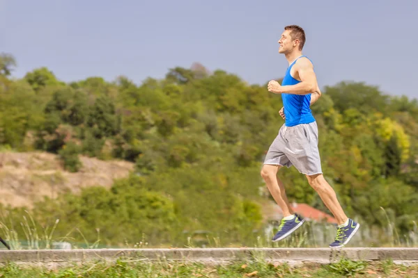 Young athlete jogging outdoors — 图库照片