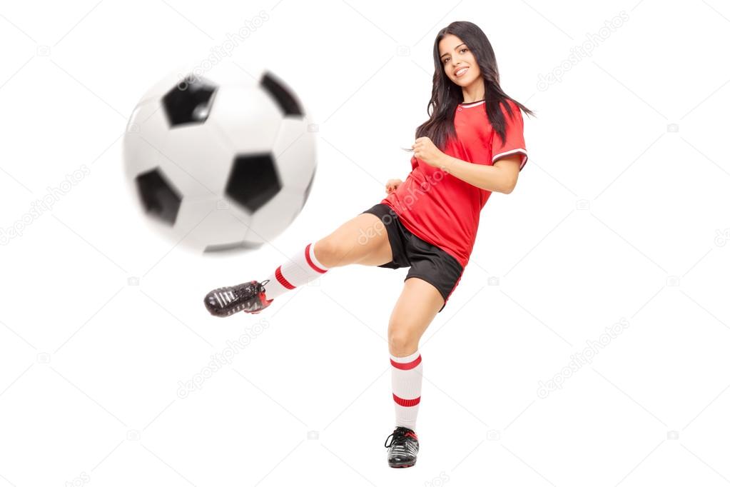 female football player shooting a ball