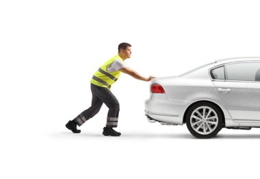 Road assistance worker pushing a car isolated on white background