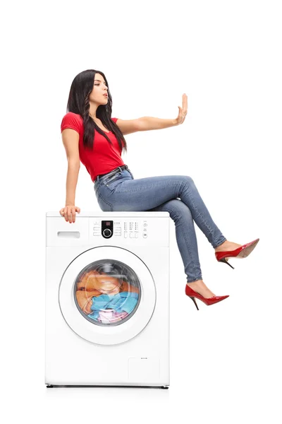 Woman waiting for the washing machine to finish — Stock Fotó