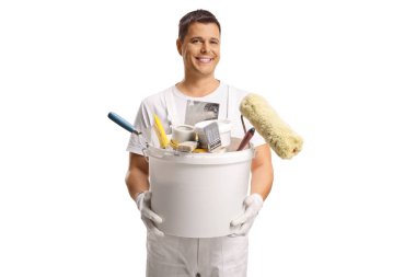 Painter holding a bucket with tools and brushes isolated on white background
