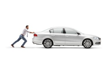 Full length profile shot of a man pushing an inoperable car isolated on white background