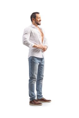 Full length shot of a man buttoning a white shirt isolated on white background